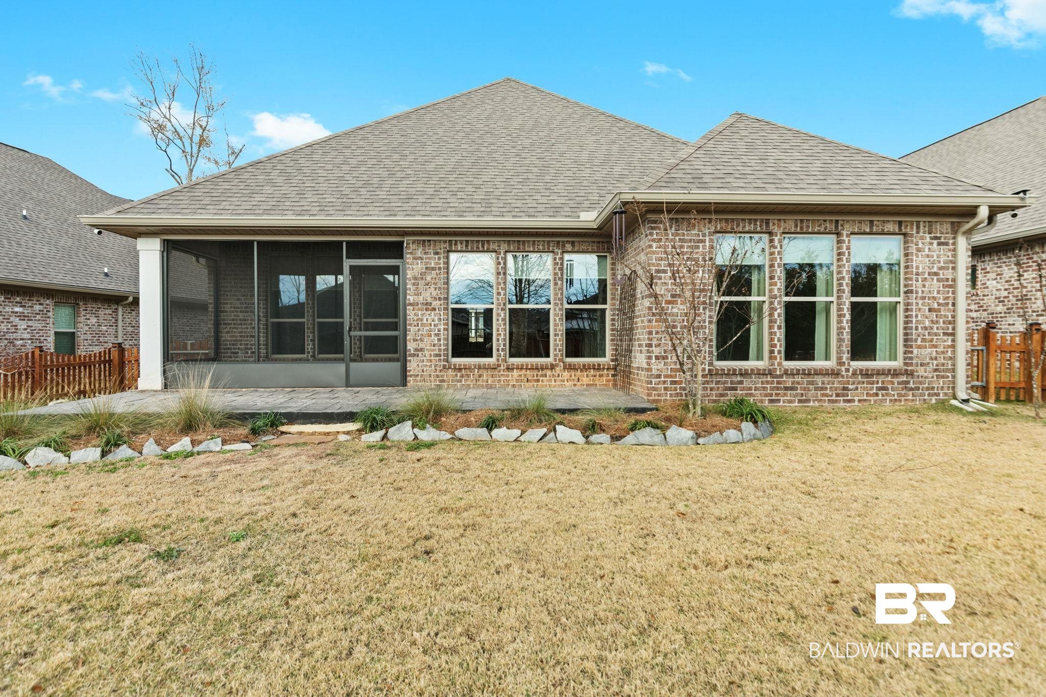 31654 Canopy Loop Daphne, AL 36527 - Photo 50 of 64 Rear view of house featuring roof with shingles, a sunroom, and brick siding