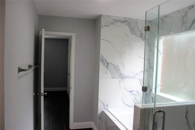 a bathroom with a shower and a mirror