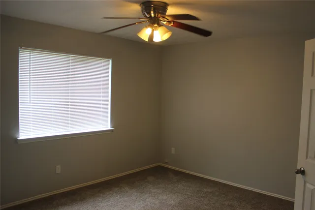 a view of a chandelier fan and fire place