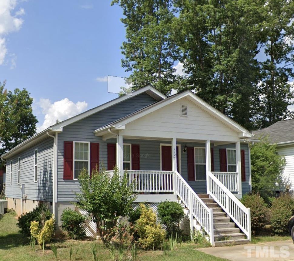 1127 Ricochet Drive Raleigh, NC 27610 - Photo 1 of 21 a front view of a house with a yard