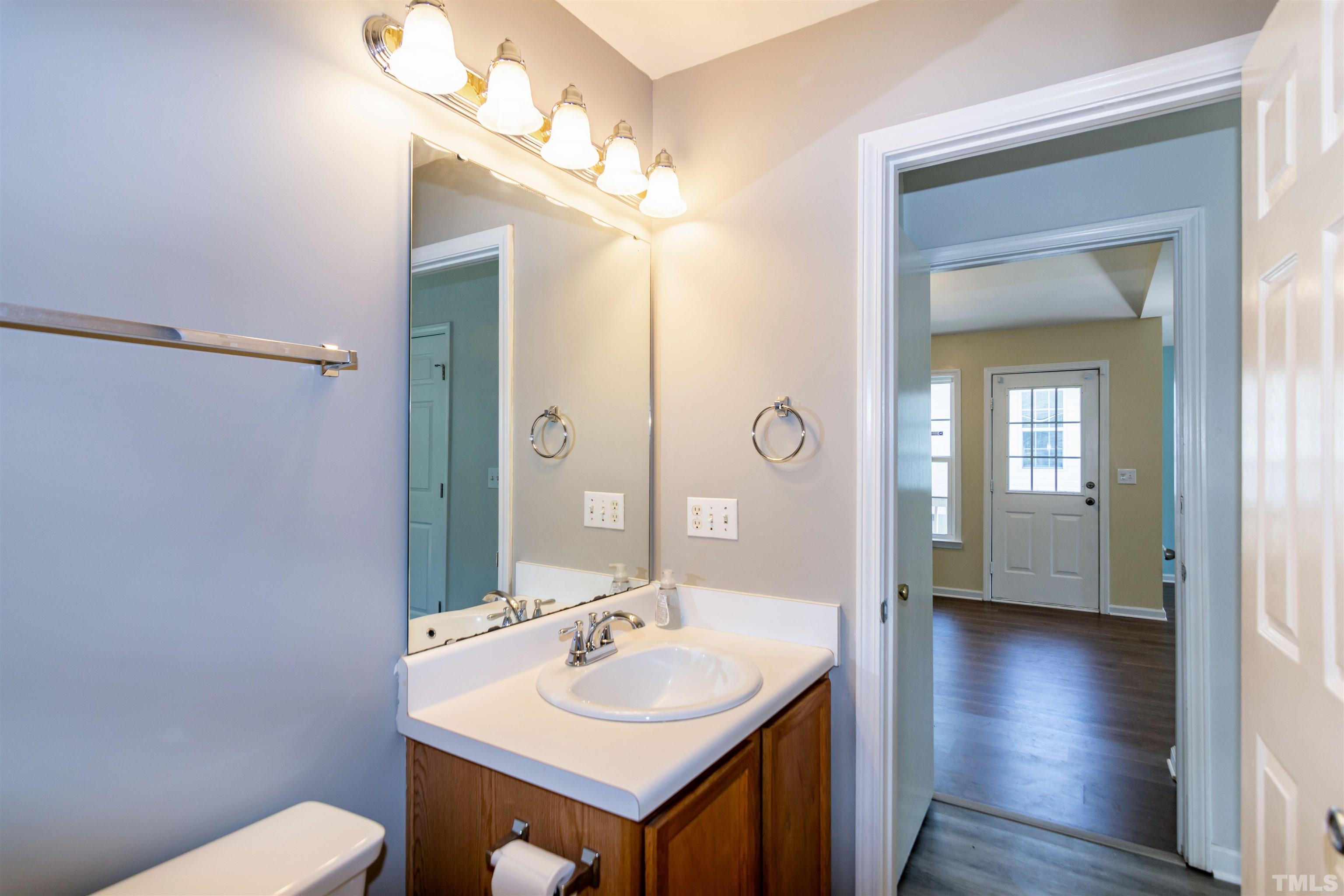 1127 Ricochet Drive Raleigh, NC 27610 - Photo 14 of 21 a bathroom with a sink a toilet and mirror