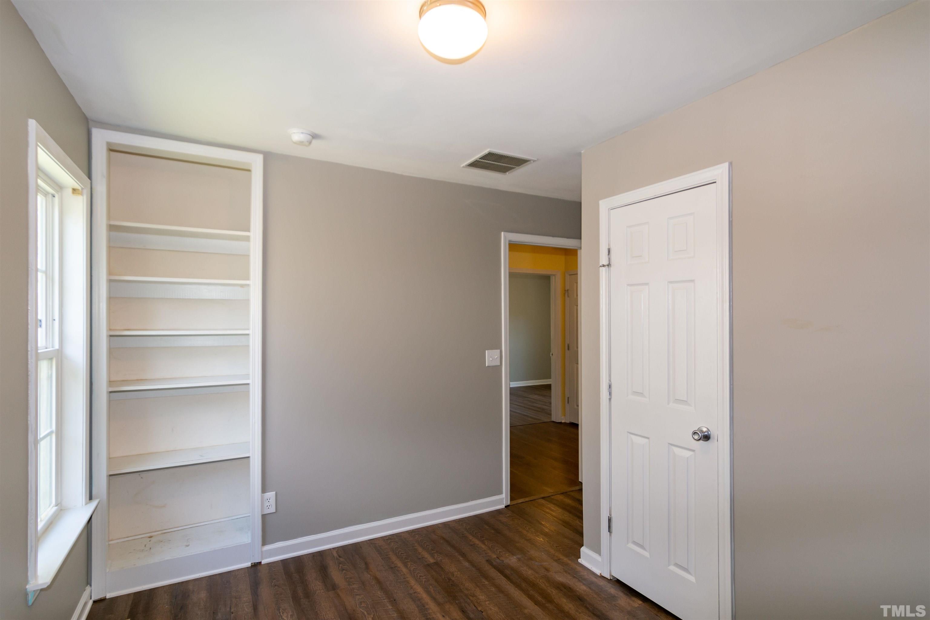 1127 Ricochet Drive Raleigh, NC 27610 - Photo 16 of 21 a view of an empty room with wooden floor and a window