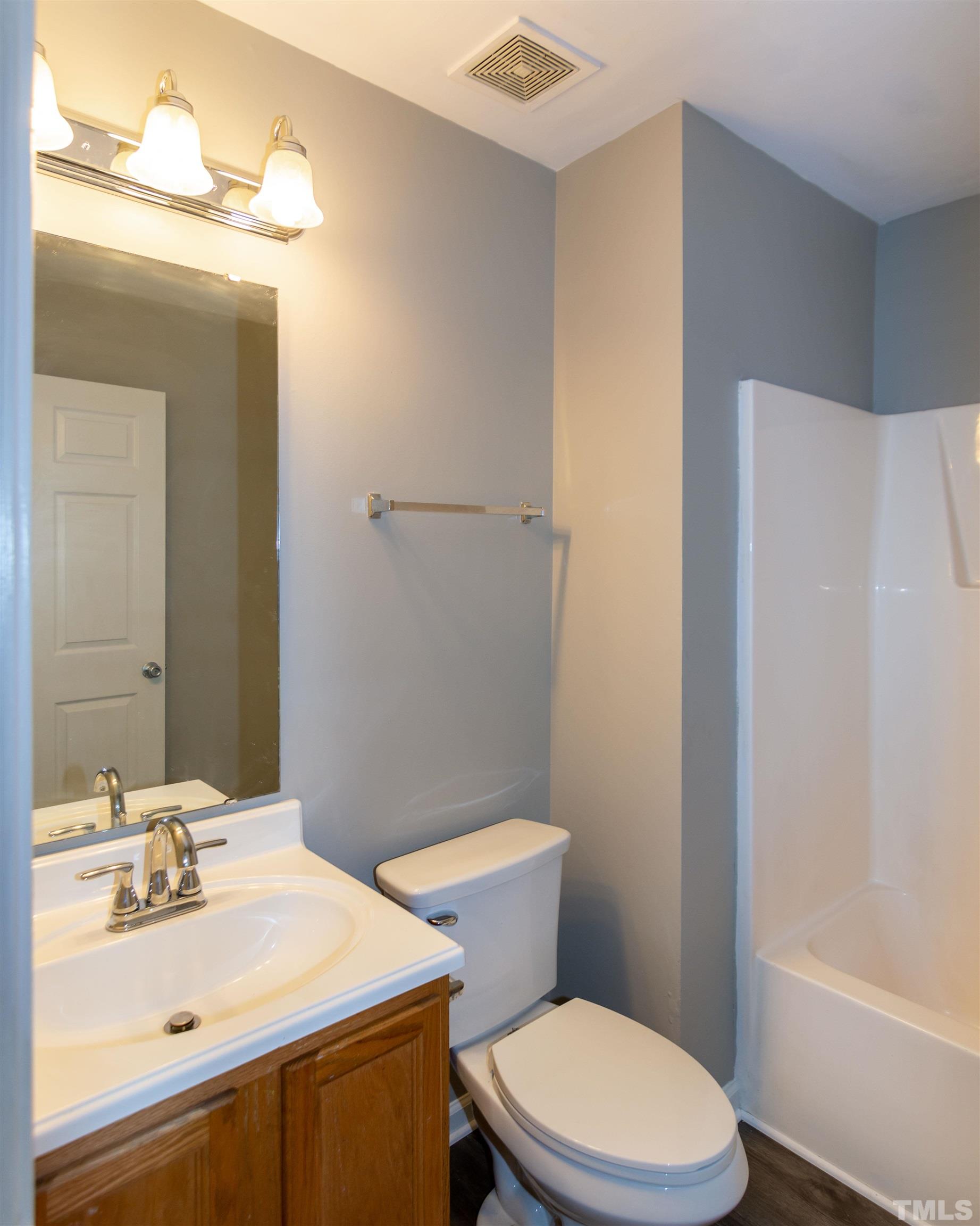 1127 Ricochet Drive Raleigh, NC 27610 - Photo 18 of 21 a bathroom with a sink toilet and shower
