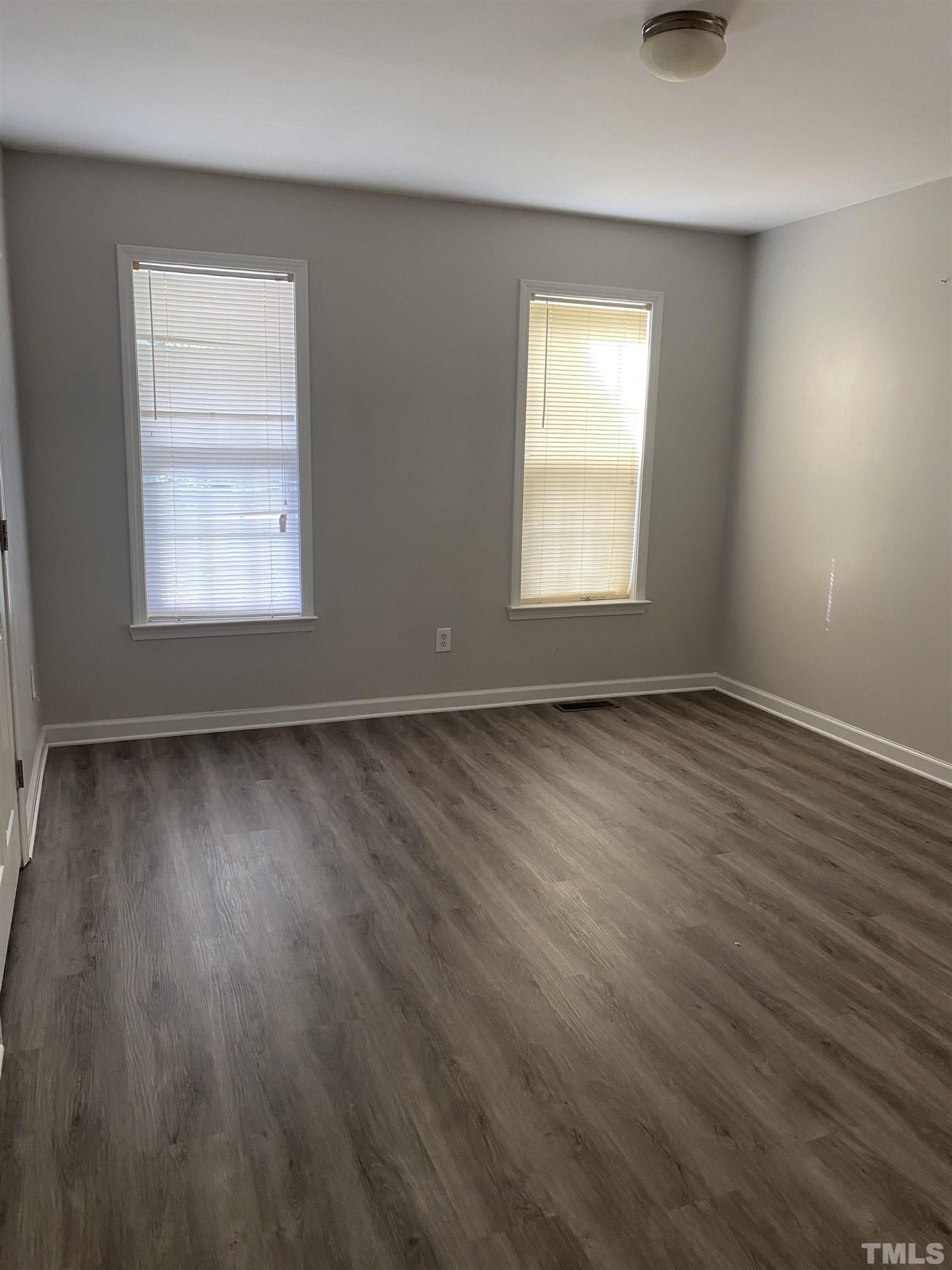 1127 Ricochet Drive Raleigh, NC 27610 - Photo 2 of 21 an empty room with wooden floor and windows