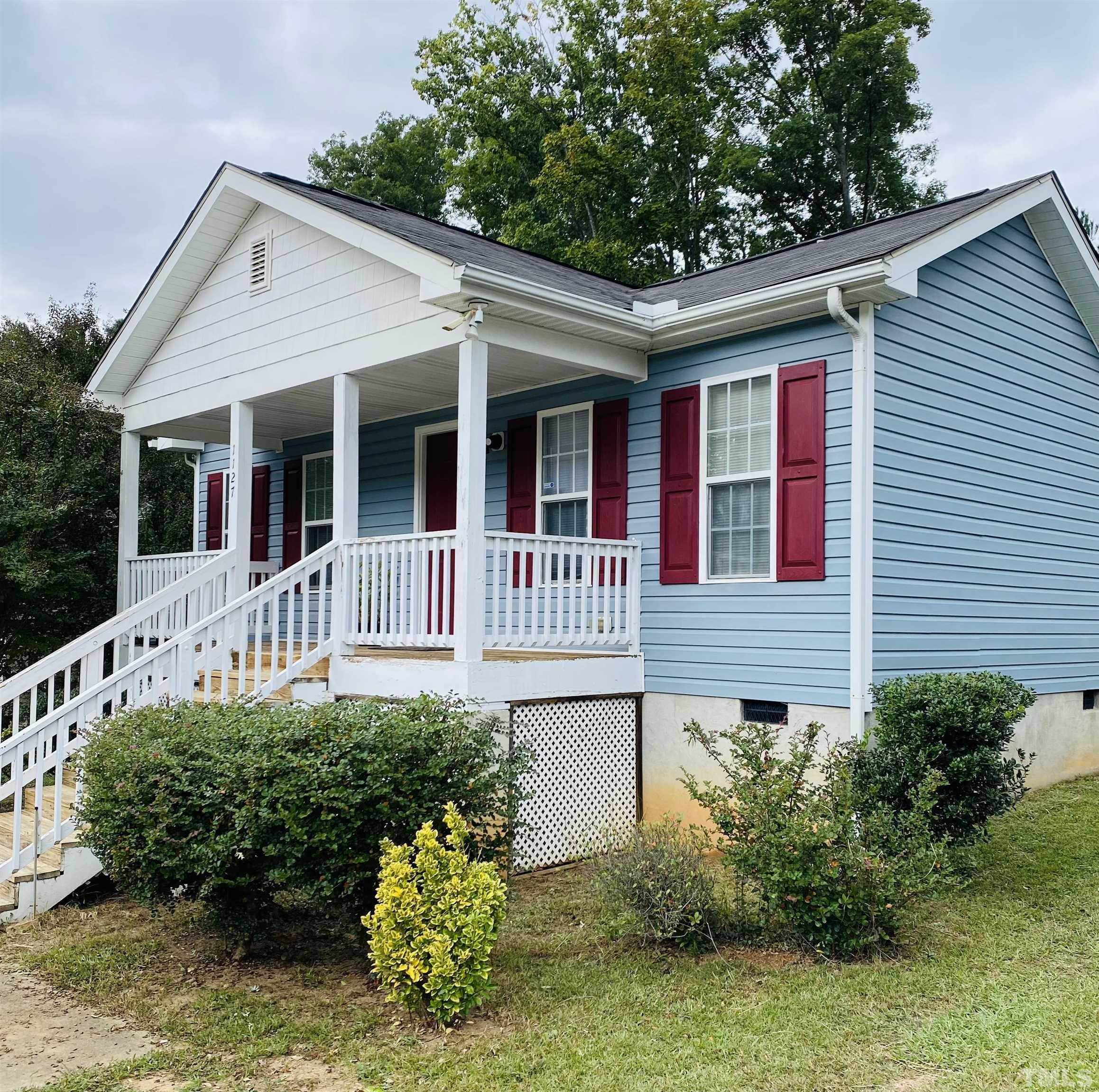 1127 Ricochet Drive Raleigh, NC 27610 - Photo 4 of 21 a front view of a house with garden