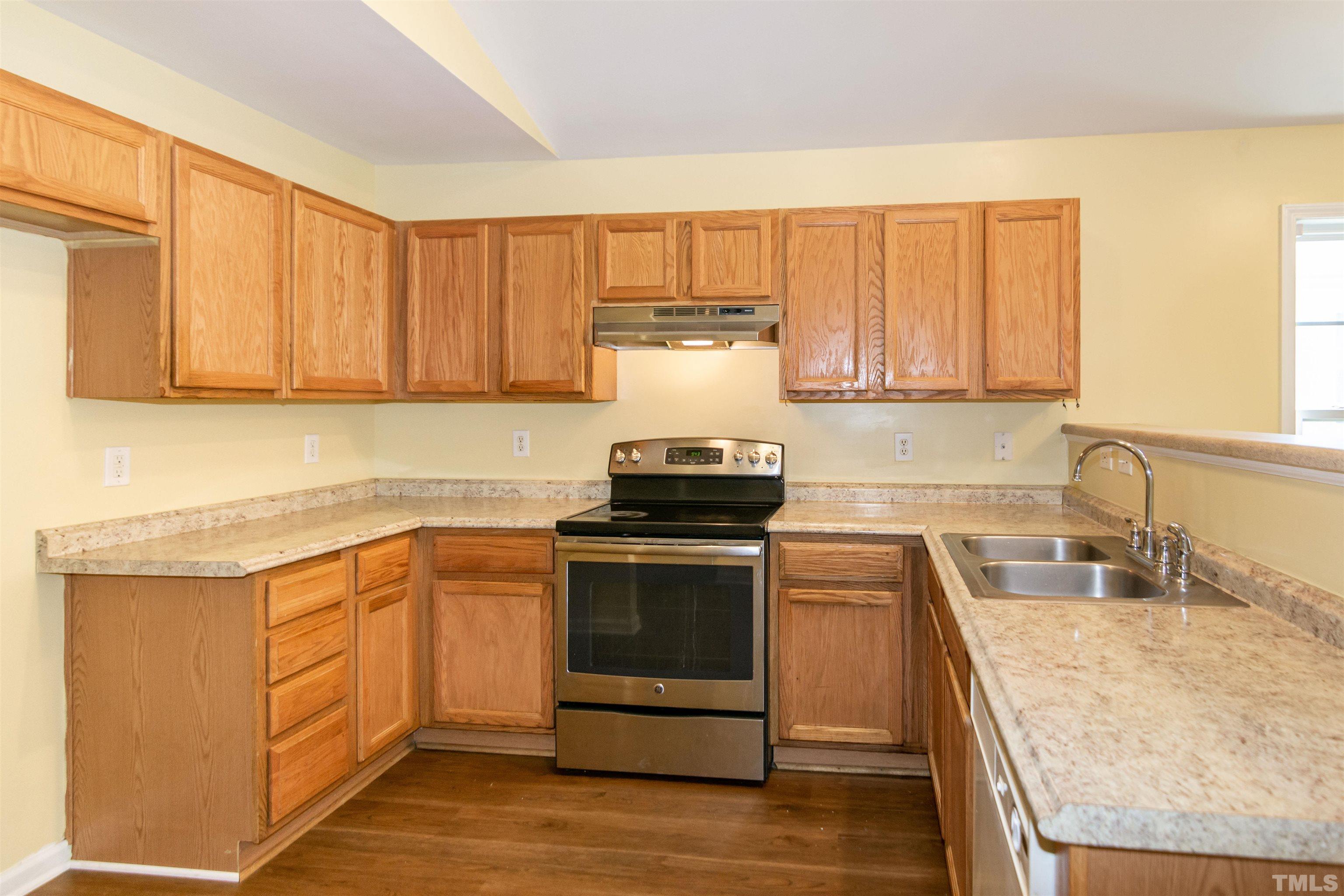 1127 Ricochet Drive Raleigh, NC 27610 - Photo 7 of 21 a kitchen with a sink stove and cabinets