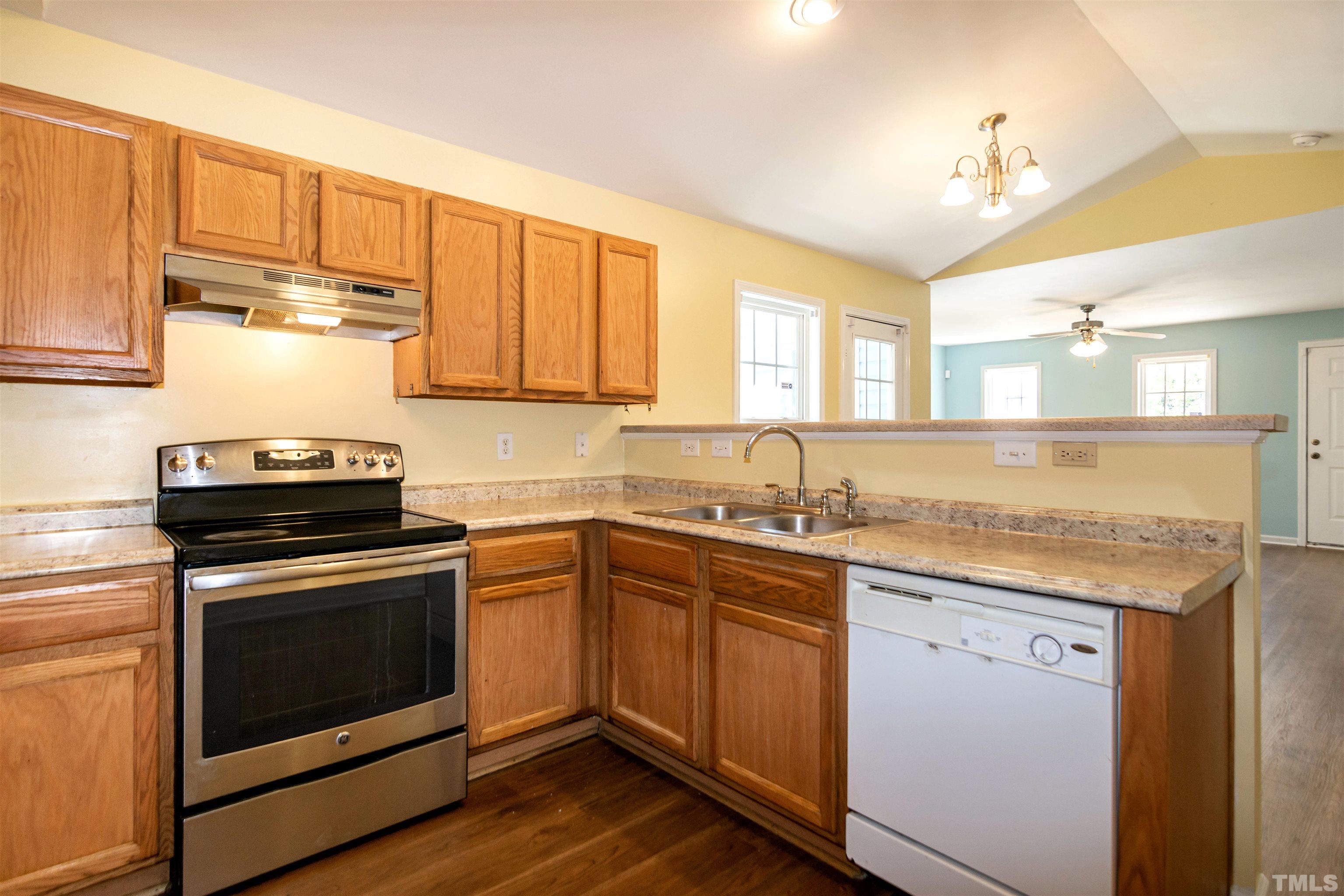 1127 Ricochet Drive Raleigh, NC 27610 - Photo 8 of 21 a kitchen with a stove sink and cabinets