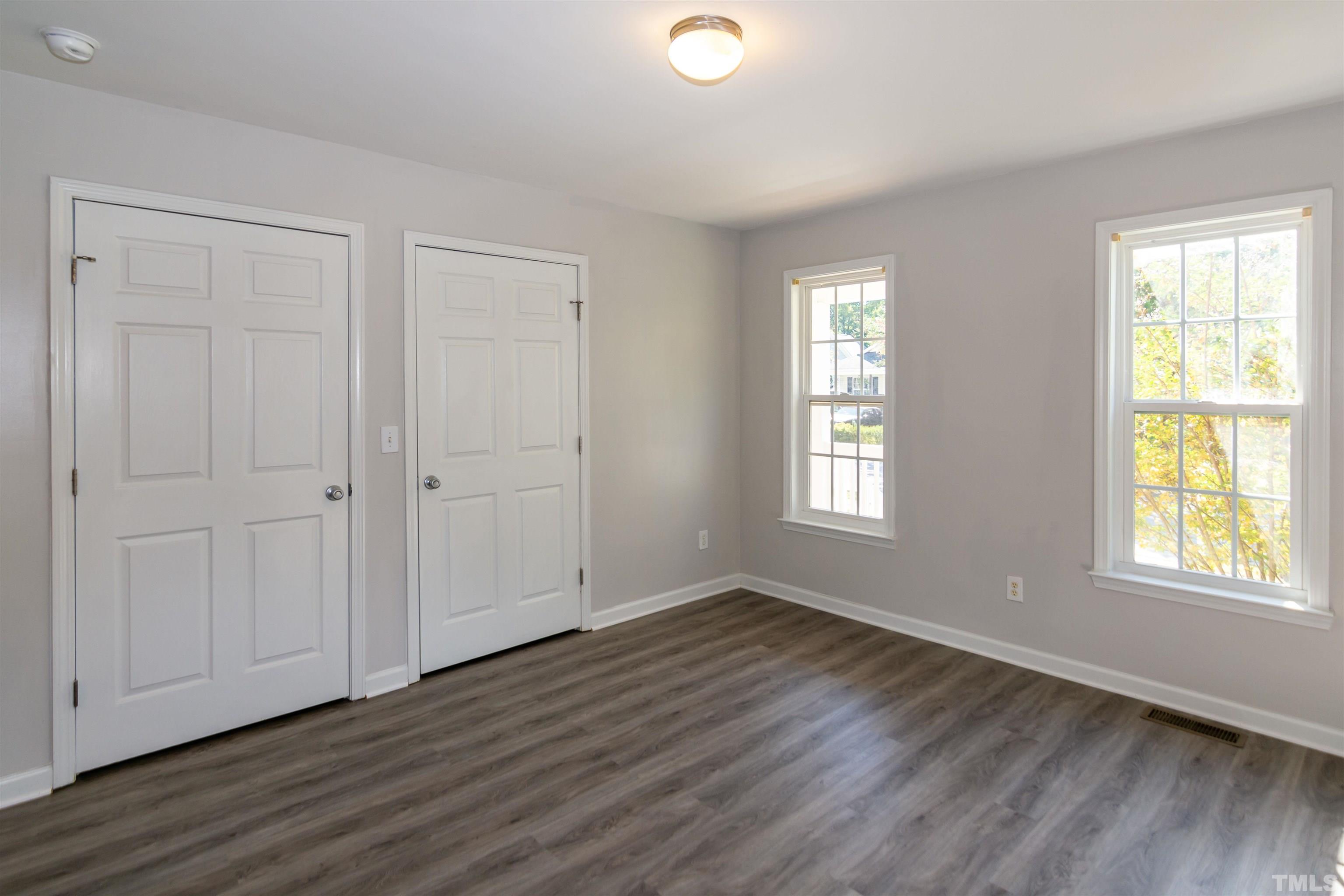 1127 Ricochet Drive Raleigh, NC 27610 - Photo 10 of 21 a view of an empty room with wooden floor and a window