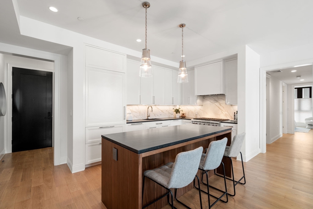100 Linden Street, Unit 103 Wellesley, MA 02482 - Photo 2 of 30 a kitchen with a table and chairs in it
