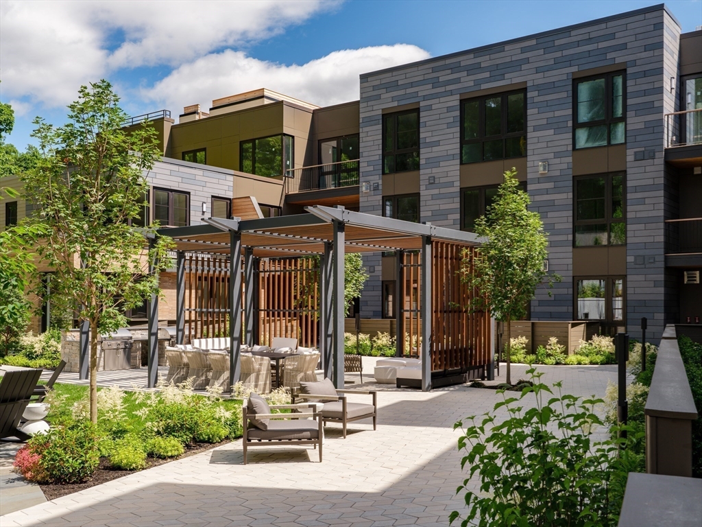 100 Linden Street, Unit 103 Wellesley, MA 02482 - Photo 27 of 30 a view of a building with sitting area