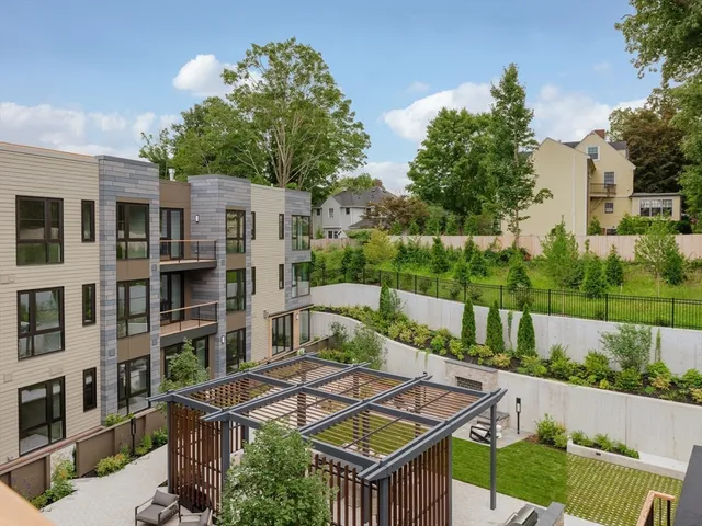 a view of a tall building next to a road