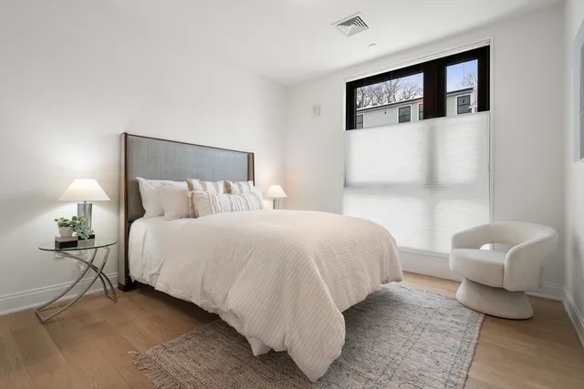 a bedroom with a bed and a lamp