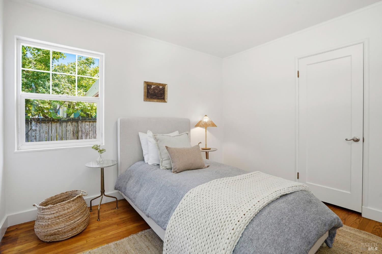 234 Solano Street San Rafael, CA 94901 - Photo 12 of 24 a bedroom with a bed and wooden floor