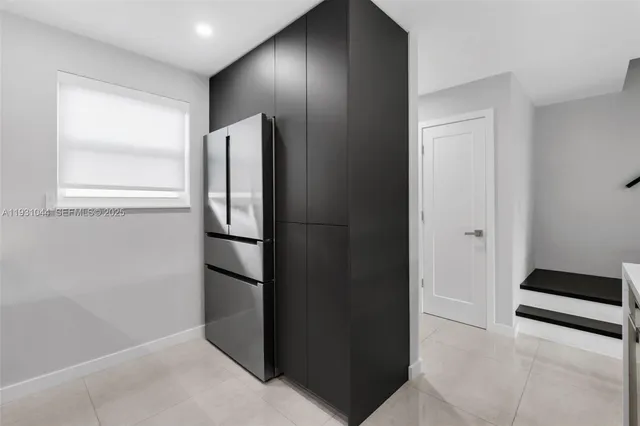 a view of kitchen with refrigerator and wooden floor