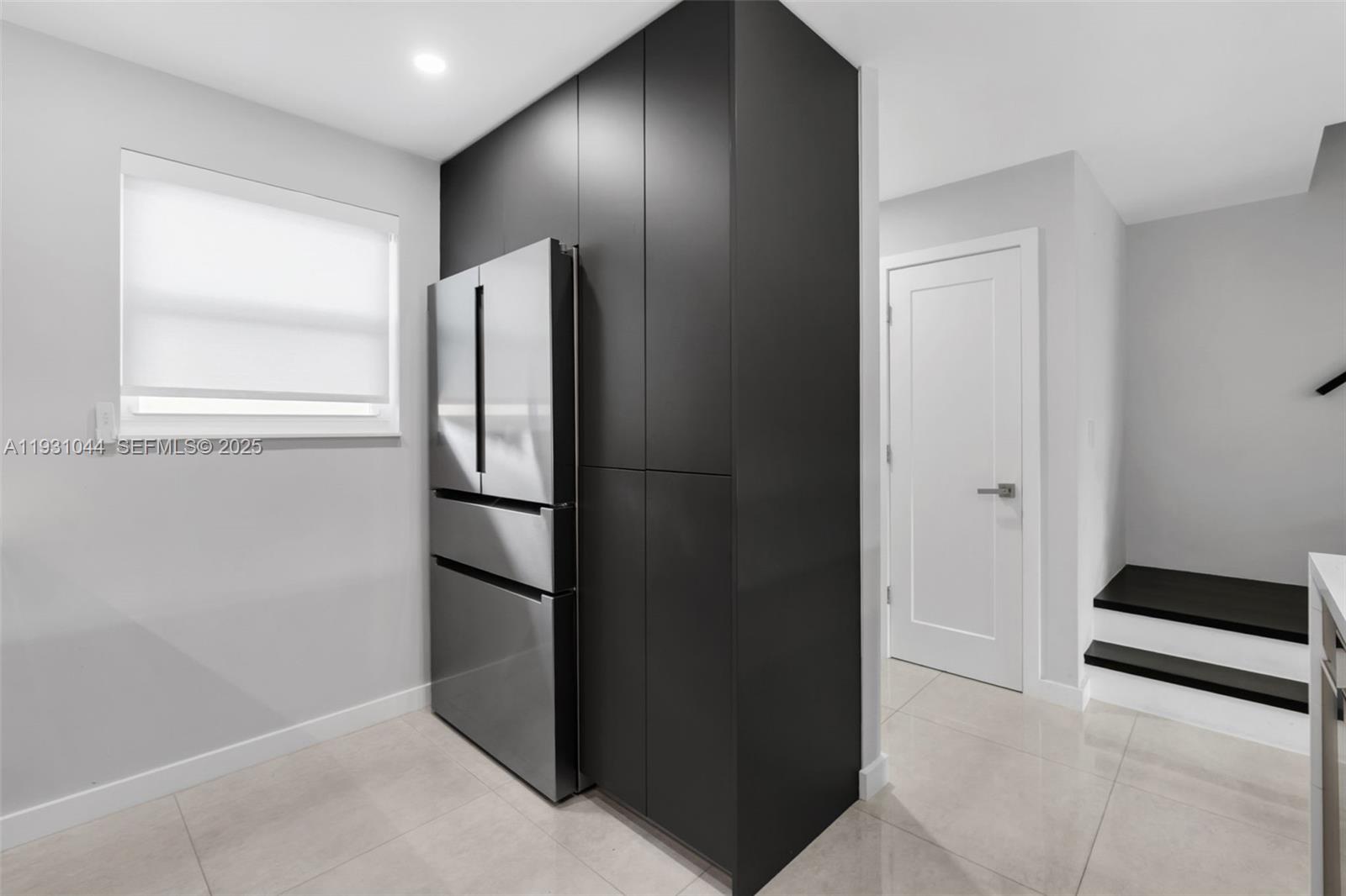 8443 Southwest 137th Avenue, Unit 8443 Miami, FL 33183 - Photo 11 of 29 a view of kitchen with refrigerator and wooden floor
