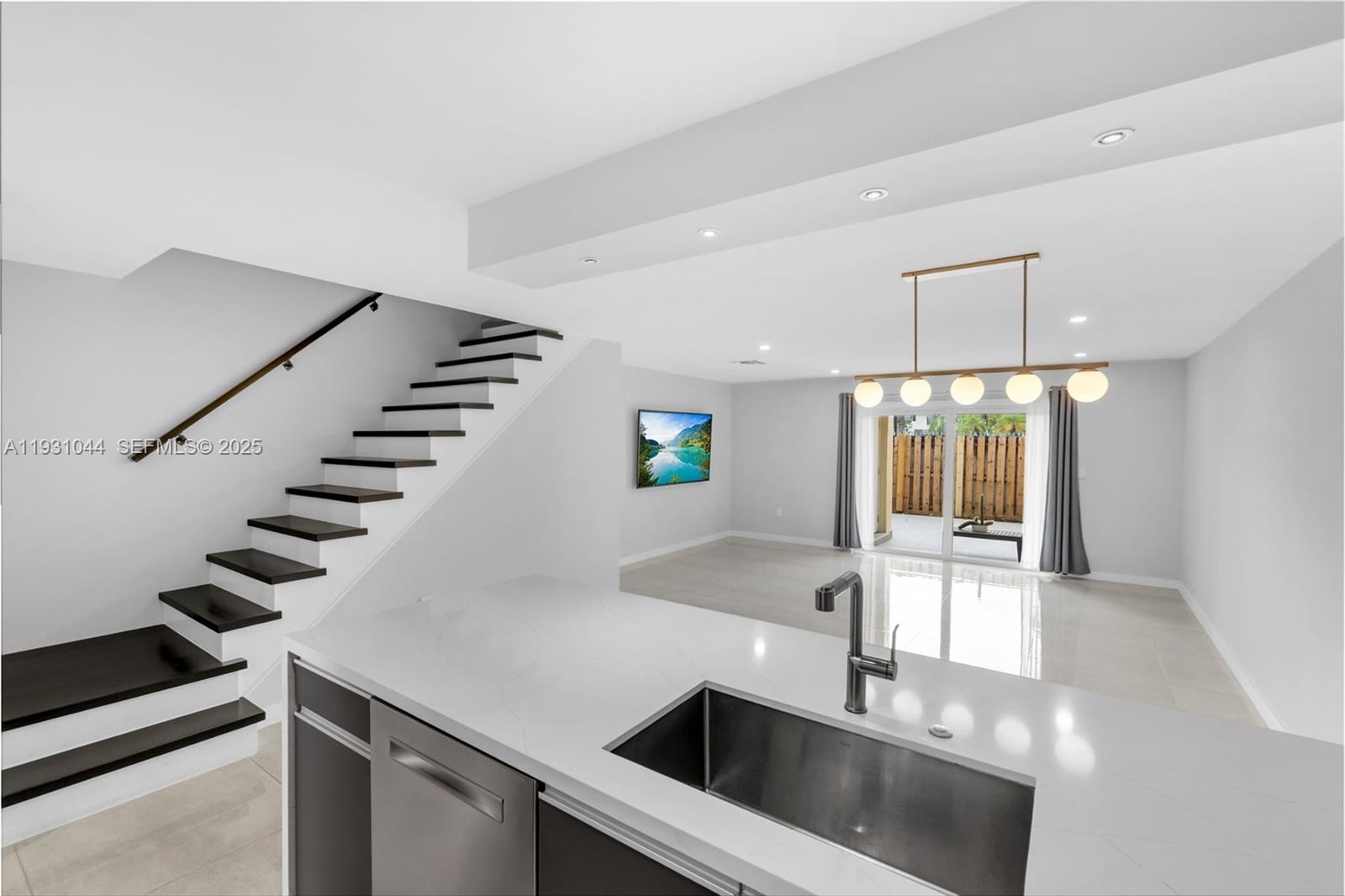 8443 Southwest 137th Avenue, Unit 8443 Miami, FL 33183 - Photo 12 of 29 a kitchen with stainless steel appliances kitchen island a sink and a refrigerator