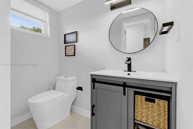 a bathroom with a toilet a sink and a mirror