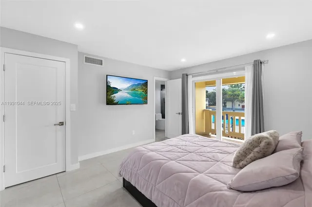 a bedroom with a large bed and a large window