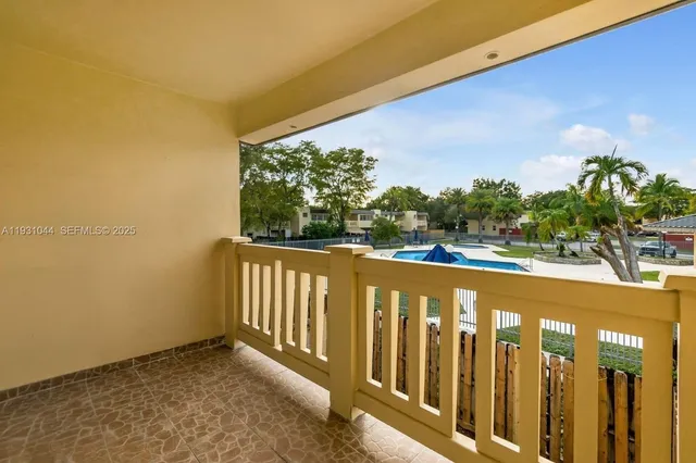 a view of a balcony with wooden floor