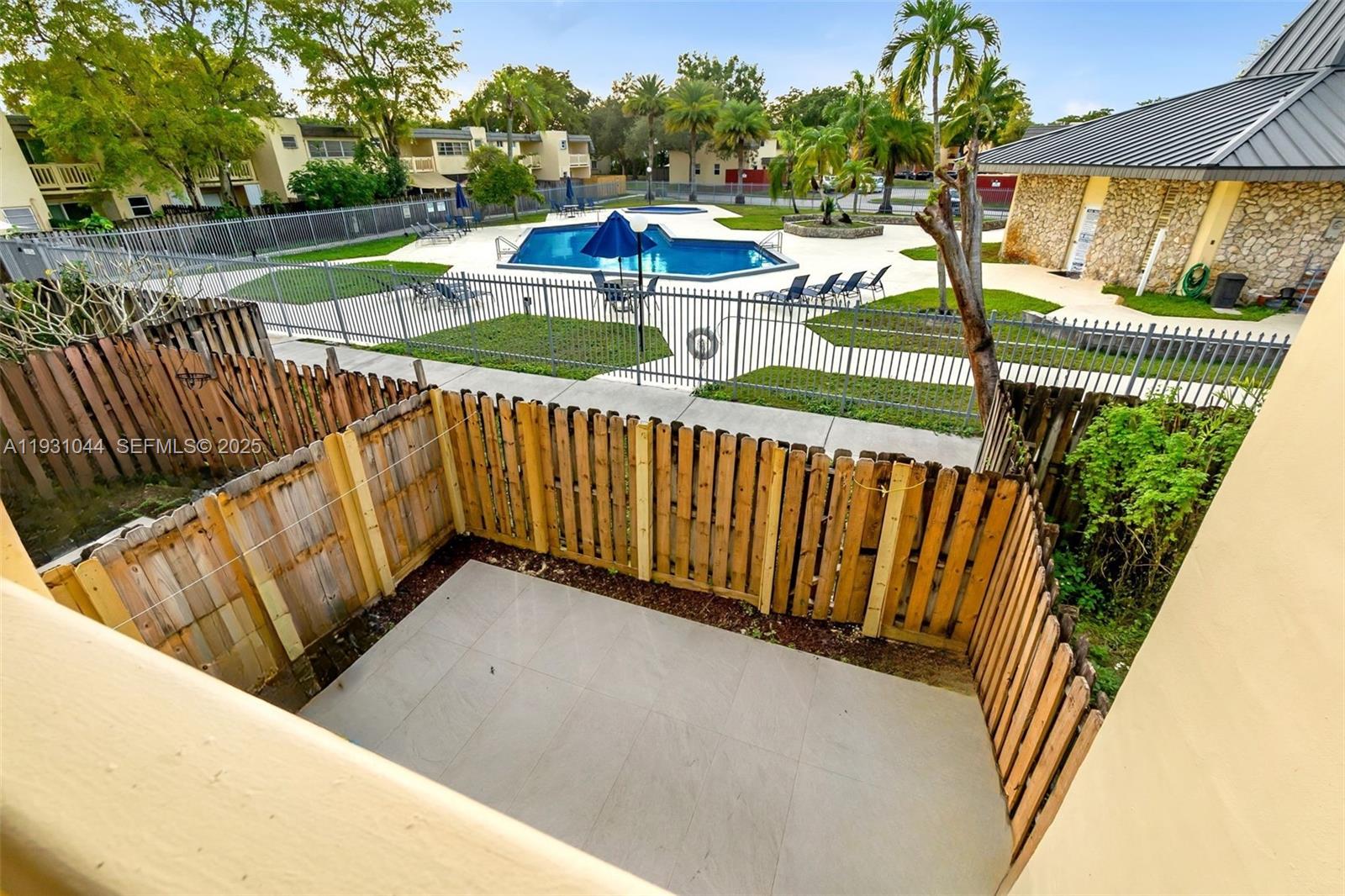 8443 Southwest 137th Avenue, Unit 8443 Miami, FL 33183 - Photo 18 of 29 a view of a balcony with wooden floor and outdoor space
