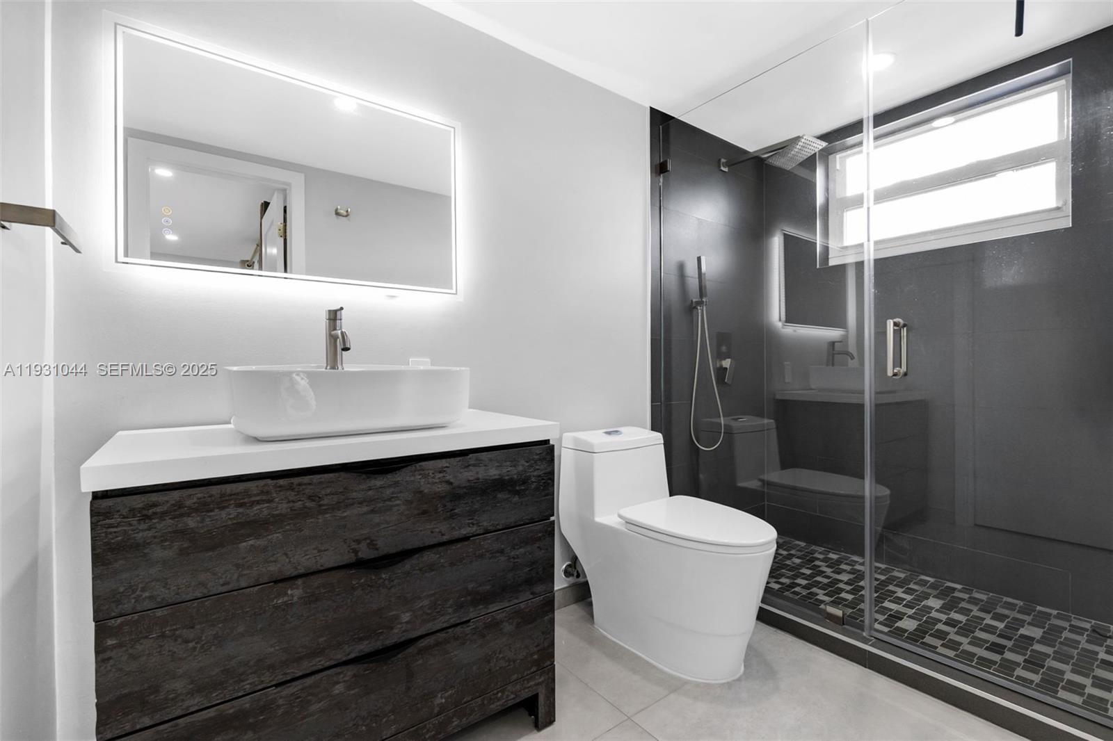 8443 Southwest 137th Avenue, Unit 8443 Miami, FL 33183 - Photo 21 of 29 a bathroom with a sink toilet and shower