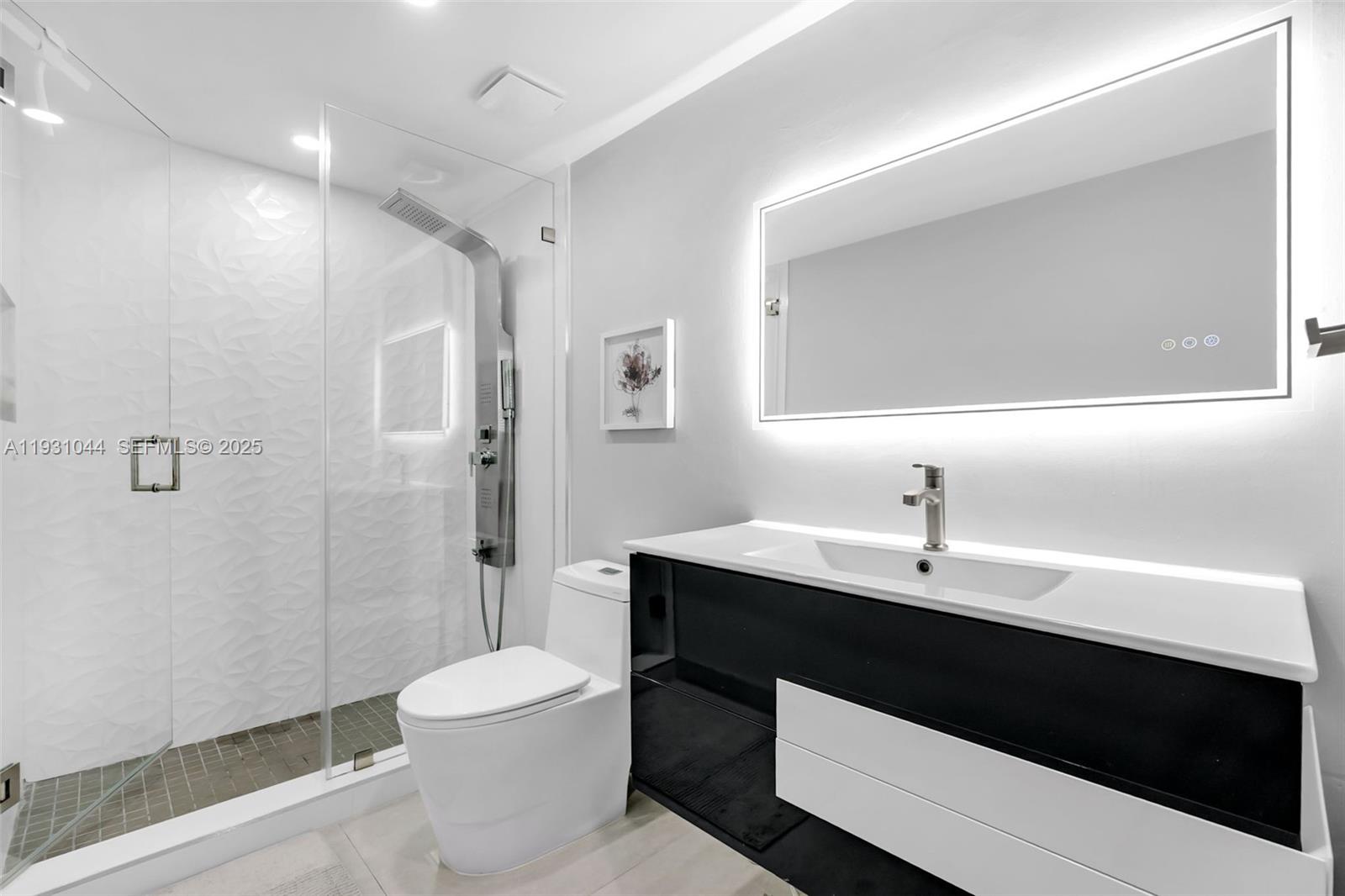 8443 Southwest 137th Avenue, Unit 8443 Miami, FL 33183 - Photo 24 of 29 a bathroom with a sink a toilet and shower