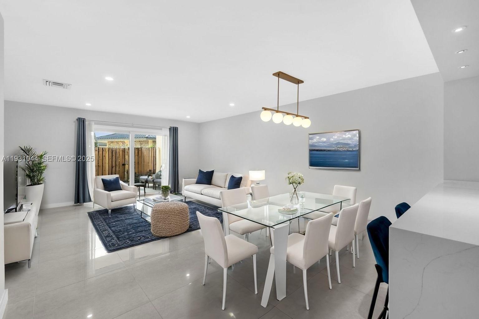 8443 Southwest 137th Avenue, Unit 8443 Miami, FL 33183 - Photo 4 of 29 a view of a dining room with furniture window and wooden floor