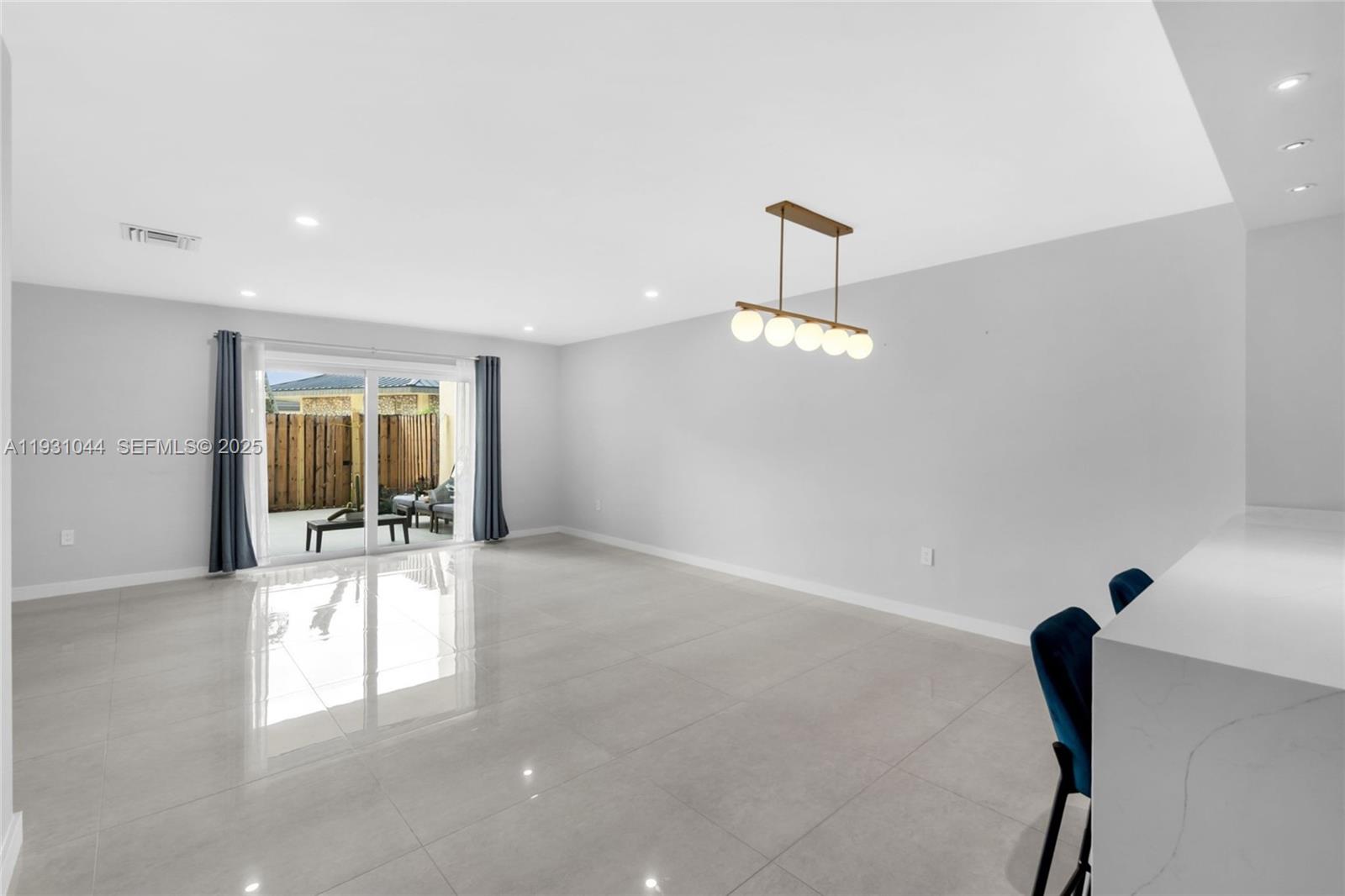 8443 Southwest 137th Avenue, Unit 8443 Miami, FL 33183 - Photo 5 of 29 a view of empty room with floor to ceiling window