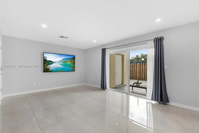 an empty room with projector and windows