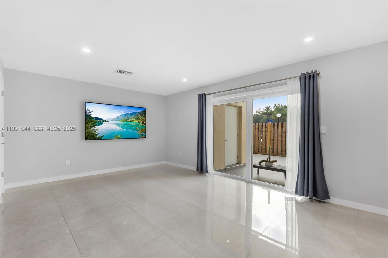 8443 Southwest 137th Avenue, Unit 8443 Miami, FL 33183 - Photo 6 of 29 an empty room with projector and windows