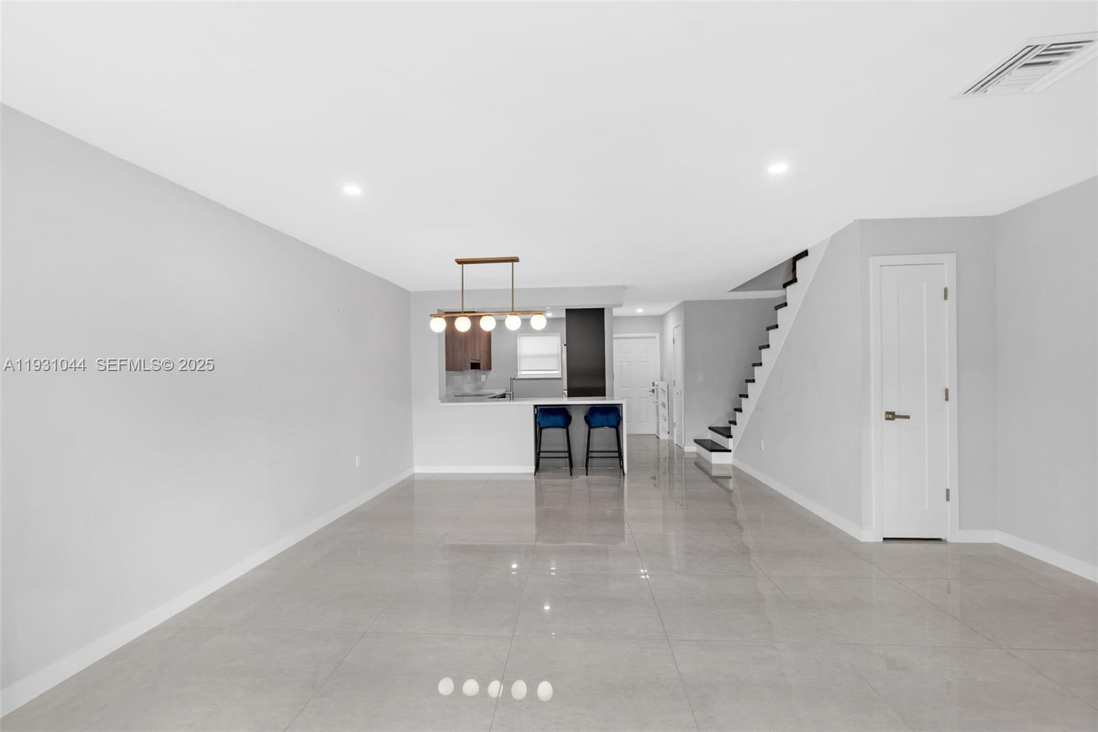 8443 Southwest 137th Avenue, Unit 8443 Miami, FL 33183 - Photo 8 of 29 a view of empty room with wooden floor