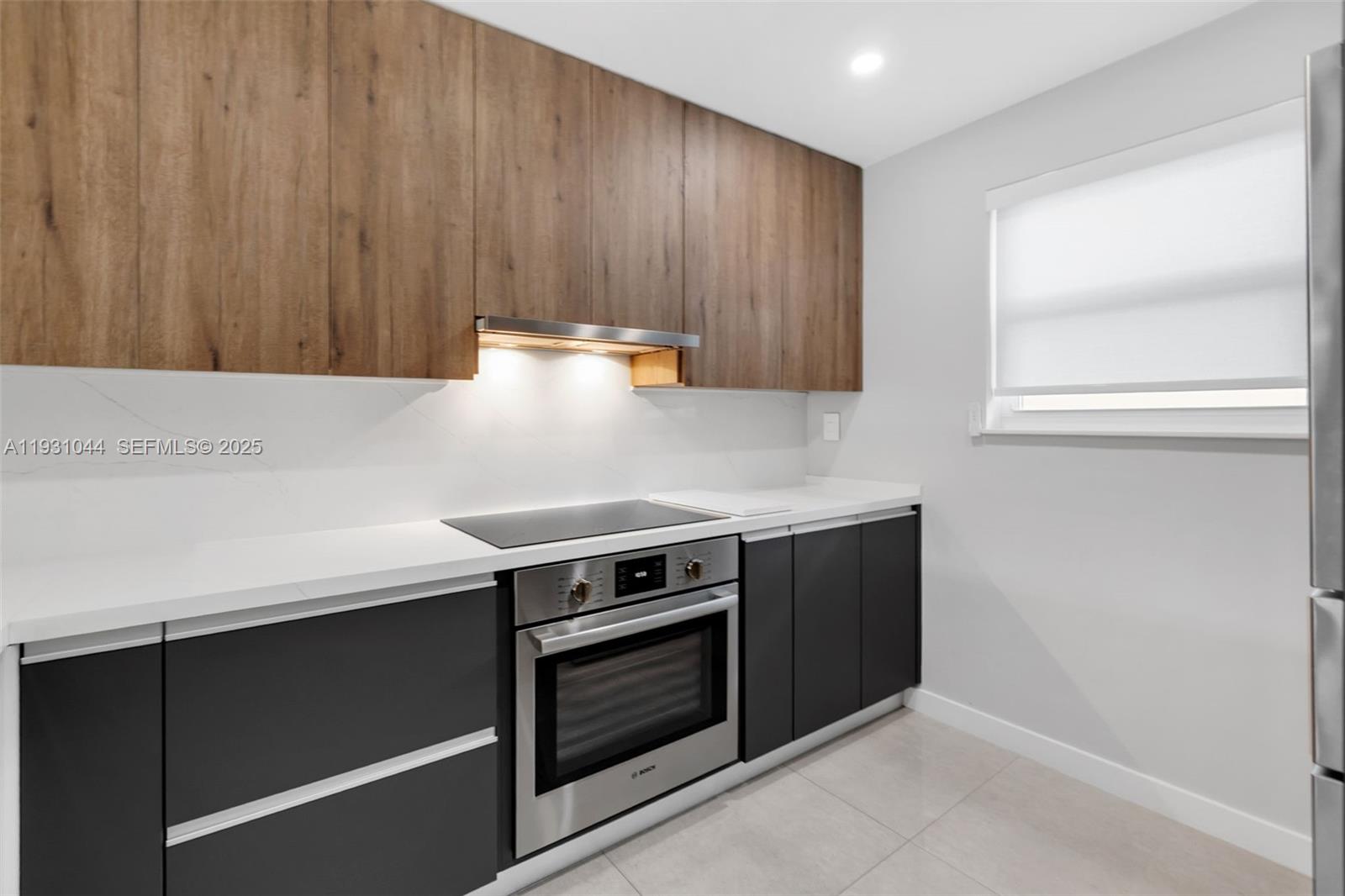 8443 Southwest 137th Avenue, Unit 8443 Miami, FL 33183 - Photo 10 of 29 a kitchen with wooden cabinets and a stove top oven
