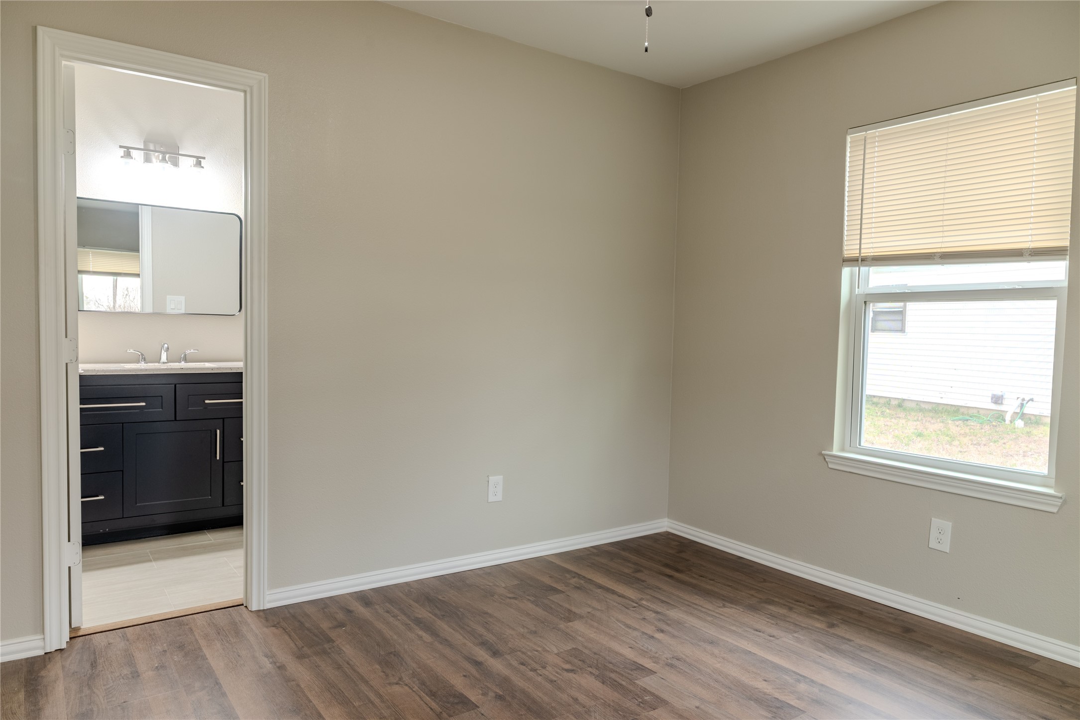 729 Planters Street Emory, TX 75440 - Photo 10 of 22 a view of an empty room with wooden floor and a window