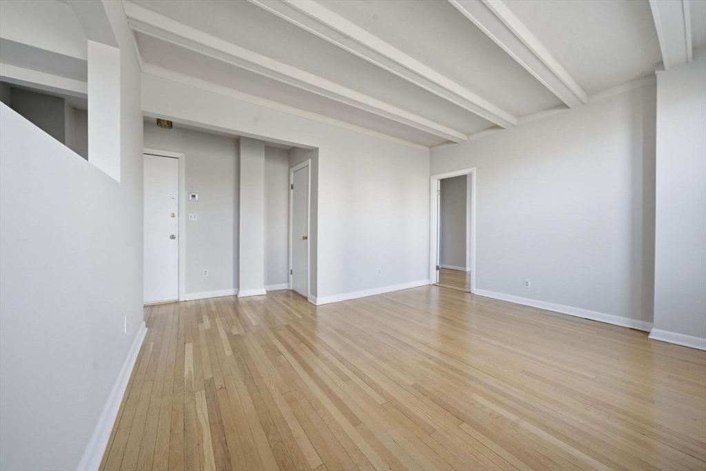 1480 Commonwealth Avenue, Unit 10 Boston, MA 02135 - Photo 9 of 19 a view of an empty room and wooden floor