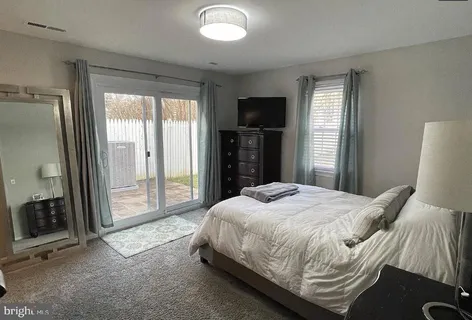 a bedroom with a bed and a television