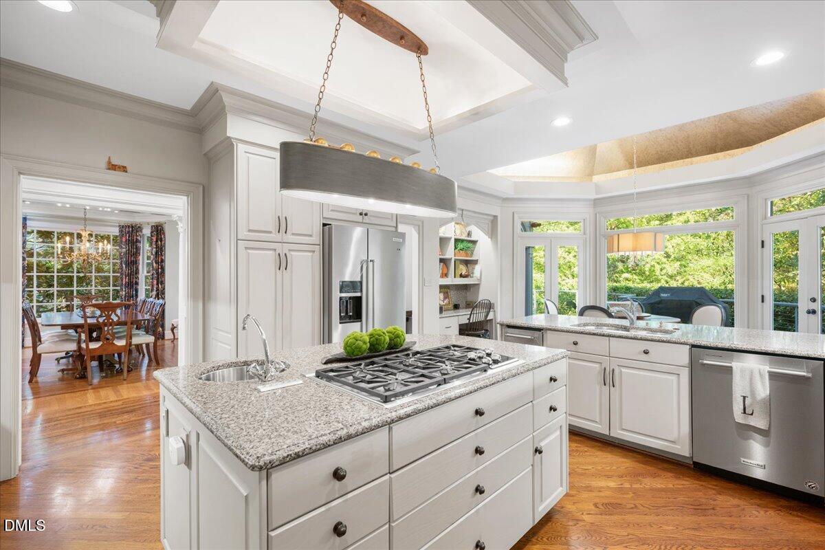 512 Hertford Street Raleigh, NC 27609 - Photo 13 of 39 a kitchen with granite countertop a sink stove and cabinets
