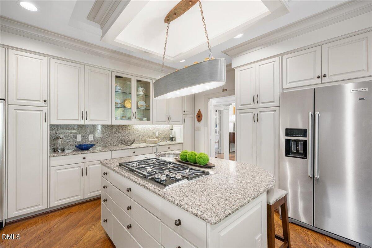 512 Hertford Street Raleigh, NC 27609 - Photo 14 of 39 a kitchen with white cabinets and stainless steel appliances