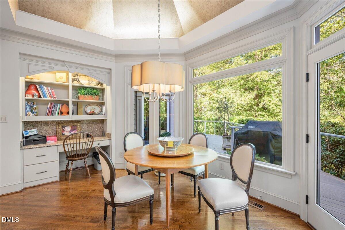 512 Hertford Street Raleigh, NC 27609 - Photo 15 of 39 a view of a dining room with furniture window and wooden floor