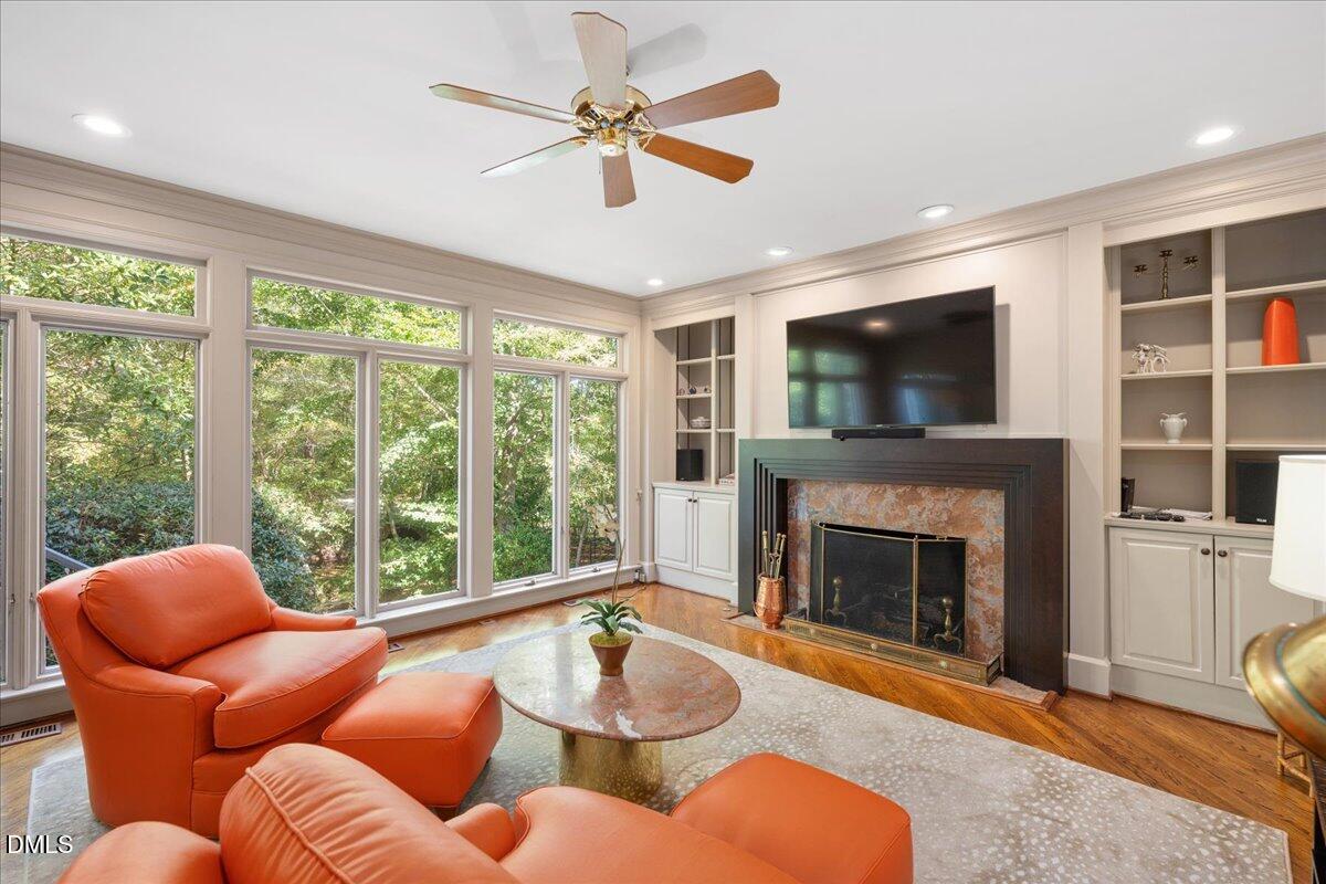 512 Hertford Street Raleigh, NC 27609 - Photo 16 of 39 a living room with furniture a fireplace and a flat screen tv