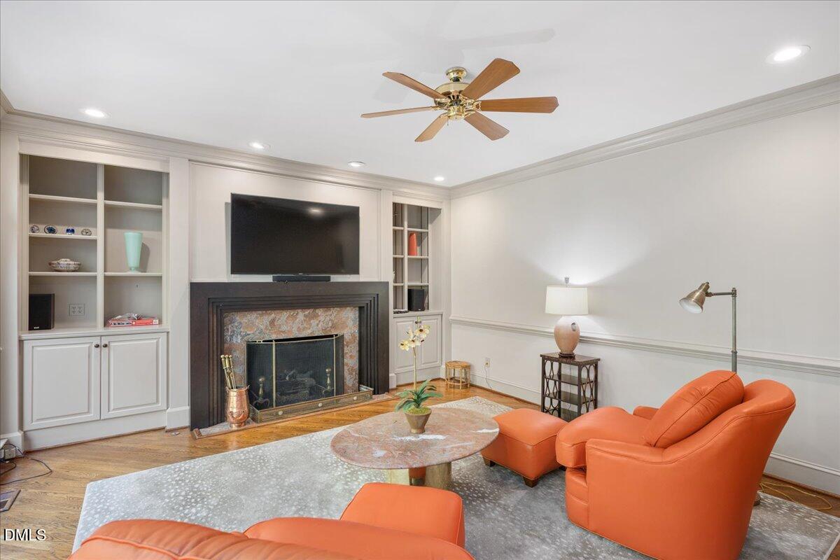 512 Hertford Street Raleigh, NC 27609 - Photo 18 of 39 a living room with furniture a fireplace and a flat screen tv