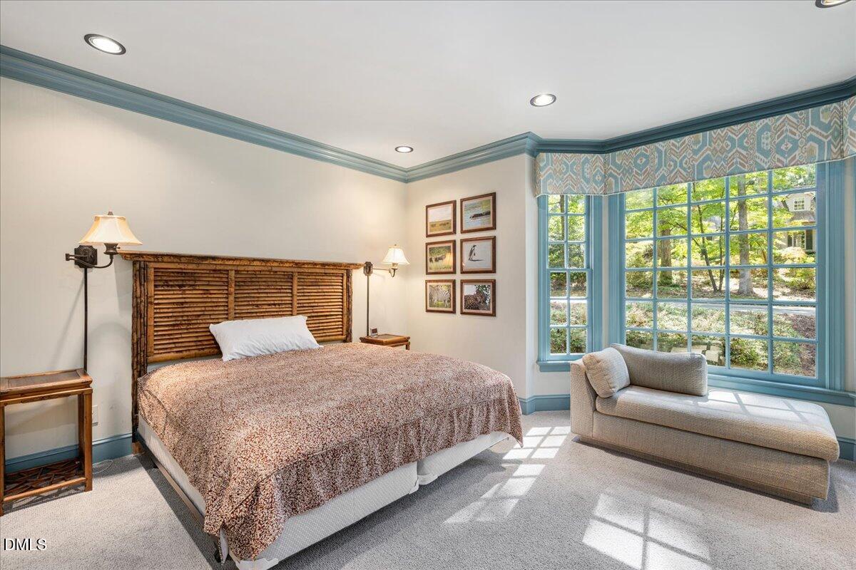 512 Hertford Street Raleigh, NC 27609 - Photo 19 of 39 a bedroom with a bed couch and a large window