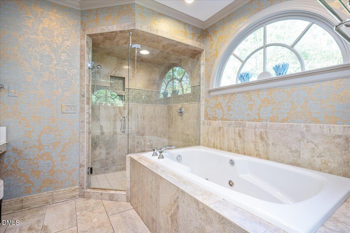 512 Hertford Street Raleigh, NC 27609 - Photo 23 of 39 a bathroom with a tub a window and glass door shower