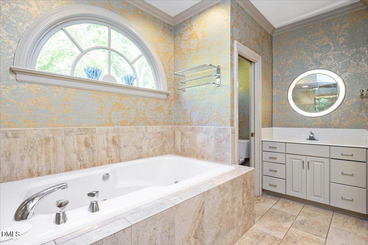 512 Hertford Street Raleigh, NC 27609 - Photo 24 of 39 a bathroom with a bathtub a sink and a window