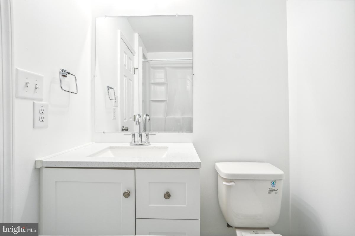 575 Primus Court Frederick, MD 21703 - Photo 14 of 31 a bathroom with a toilet a sink and mirror