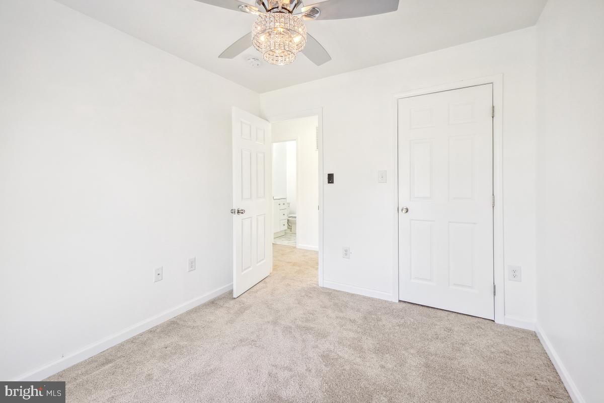 575 Primus Court Frederick, MD 21703 - Photo 22 of 31 an empty room with a chandelier fan and closet