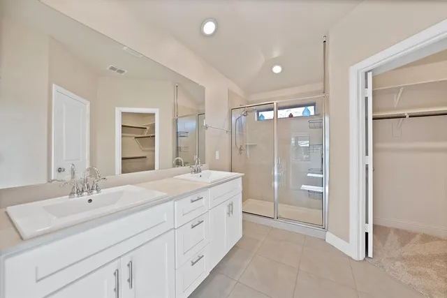a spacious bathroom with a shower sink double and mirror