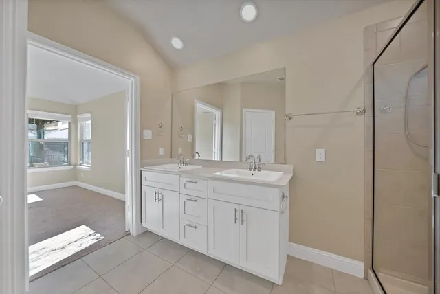 a bathroom with a granite countertop sink two mirror and a