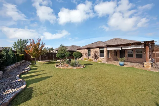 a view of a house with swimming pool and sitting area