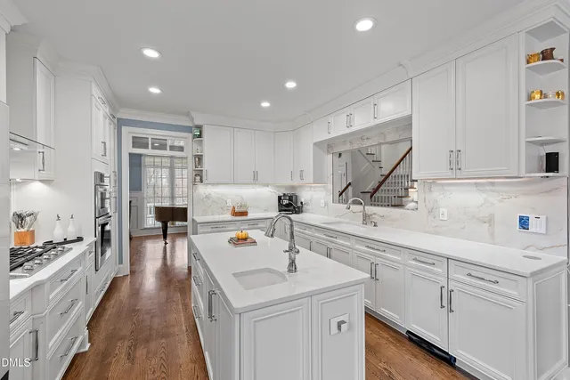 a sink with white cabinets
