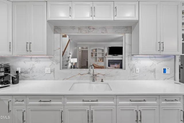 a kitchen with stove and cabinets